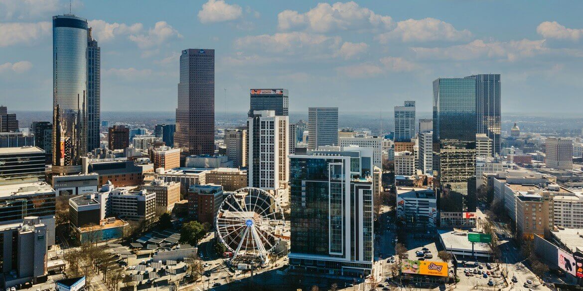 A view of the Atlanta skyline, showing skyscrapers and a blue sky.