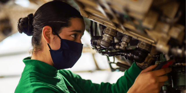 Sailor conducts maintenance on an aircraft