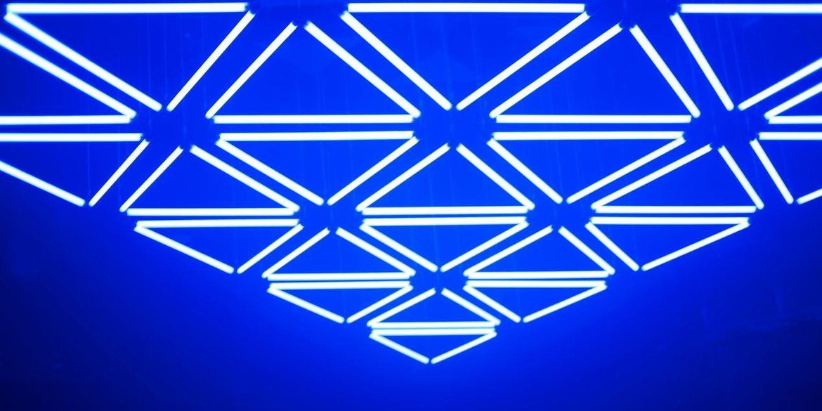 Several neon triangles with blue background