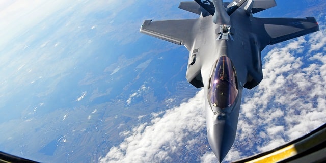 Fighter aircraft being refueled midflight